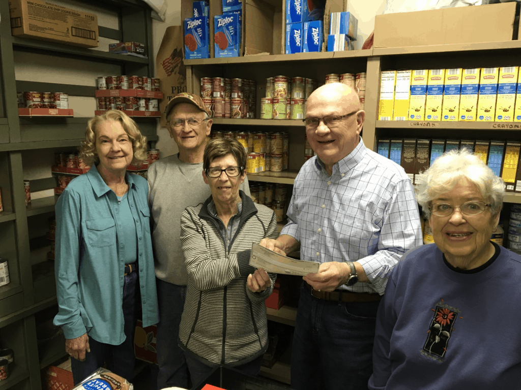 Volunteers at the Seneca Food Pantry accept a grant check for Davis Fund chair Fran Kasten