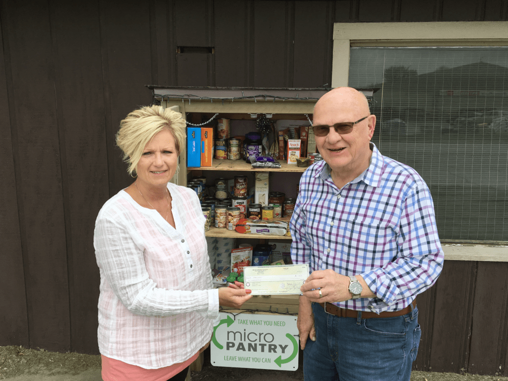Kathy Haralson accepts a grant check for the Seneca Micro Food Pantry